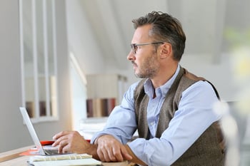 Businessman at home looking away through window