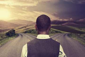 Businessman deciding on which path to take