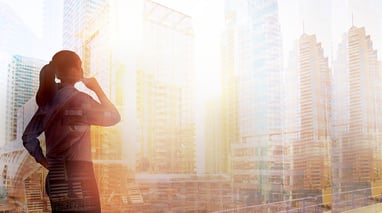 office worker looking out at city skyline