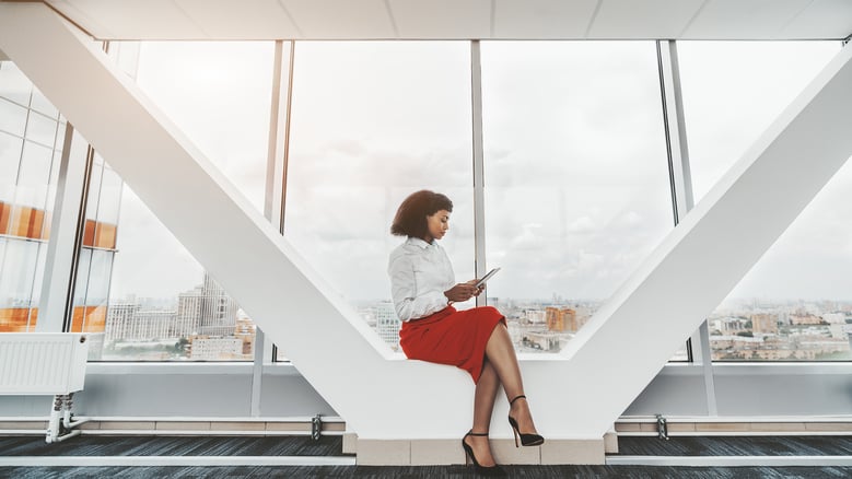 woman in an office looking at her phone