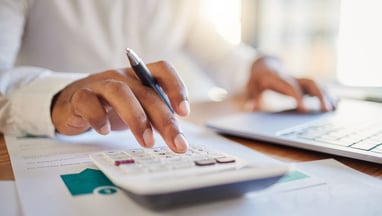 finance workers crunching the numbers on a calculator