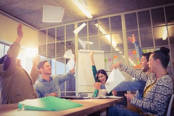 Group of business people celebrating by throwing their business papers in the air-1