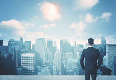 businessman looking at city skyline
