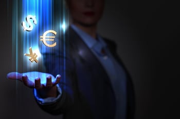 Businesswoman with financial symbols coming from her hand