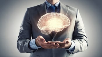 Close up of businessman holding digital image of brain in palm