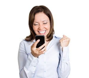 Closeup portrait, happy, cheerful, mature woman, excited by what she sees on his cell phone, isolated white background. Positive human emotions, facial expression, feelings, reaction