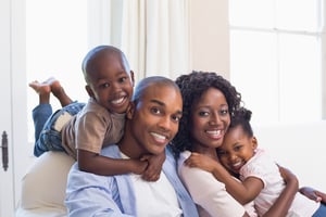 Happy family posing on the couch together at home in the living room