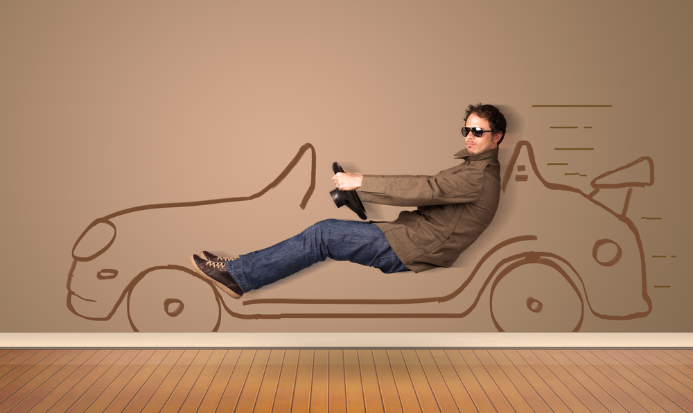 Happy man driving an hand drawn car on the wall concept