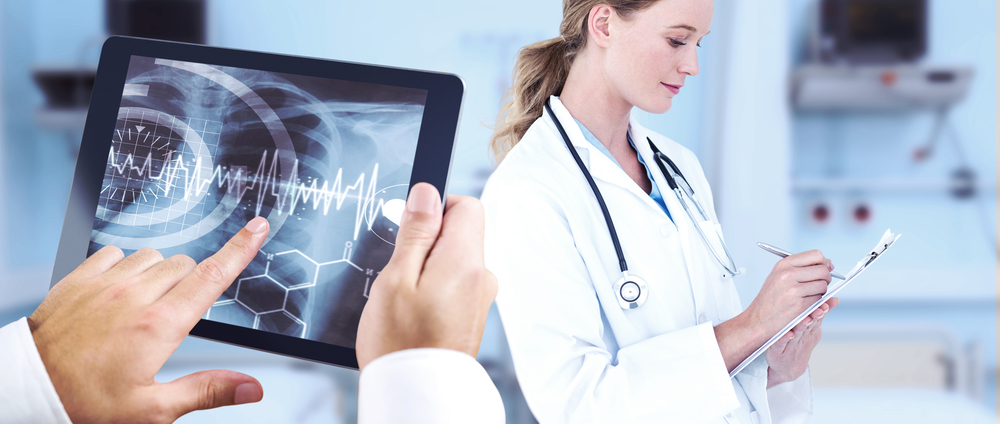 Man using tablet pc against sterile bedroom