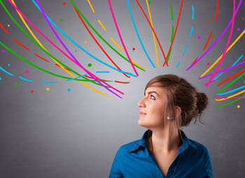 Pretty young girl thinking with colorful abstract lines overhead