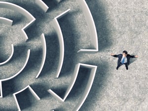 Top view of successful businessman standing near the entrance of labyrinth-2