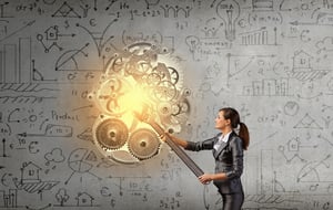 Young businesswoman fixing gears mechanism with wrench