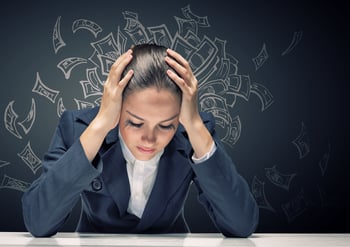 Young troubled businesswoman with hands on head