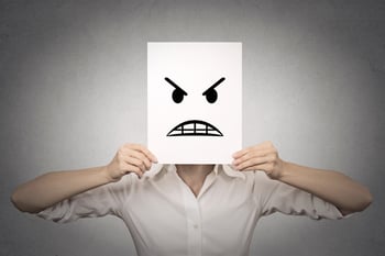 businesswoman covering her face with angry mask isolated grey wall background. Negative emotions, feelings, expressions, body language-1