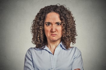 headshot angry woman isolated on grey wall background. Negative face expression body language