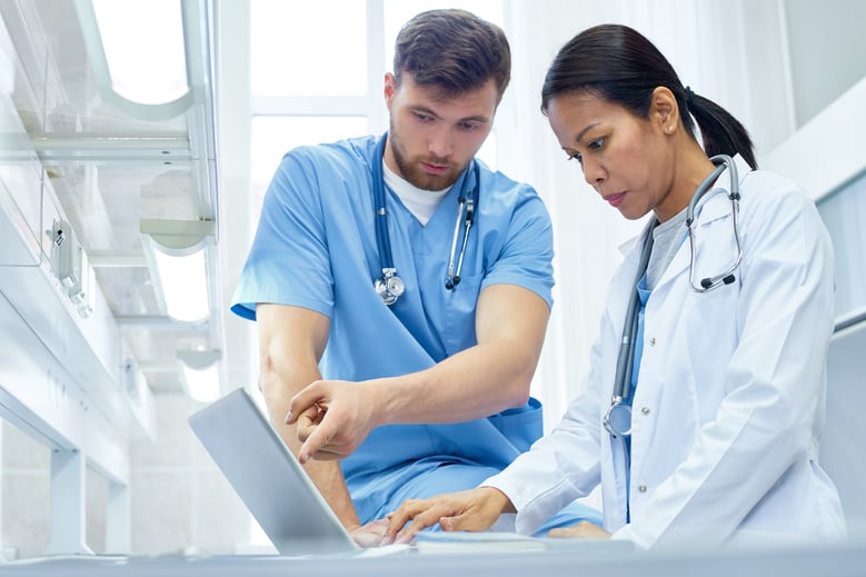 Healthcare professionals analyzing information displayed on a computer