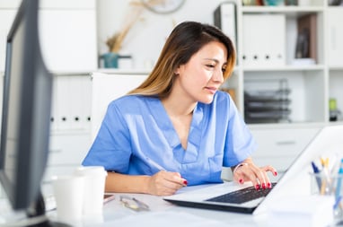 healthcare professional conducting telehealth consult on a laptop