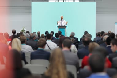 doctor addressing clinical research community at a conference