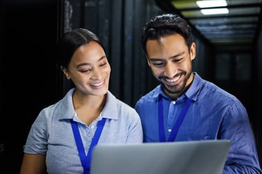 cloud professionals looking at a laptop screen
