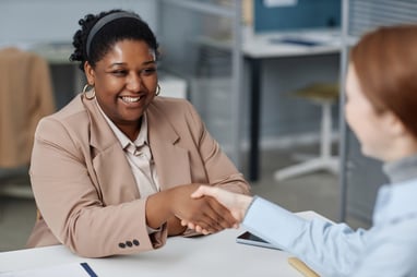 Hiring manager shaking new employee's hand