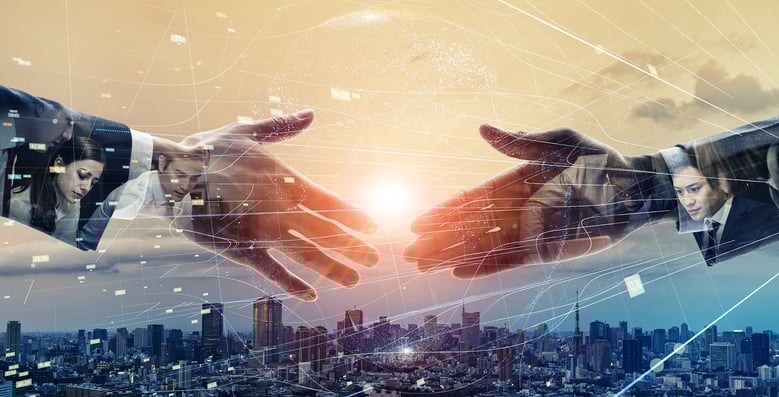 hands meeting above city skyline