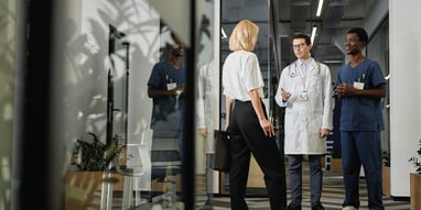 Healthcare team consisting of a doctor, nurse, and consultant/manager.