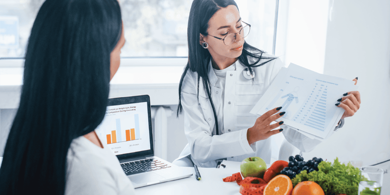 Allied health professional (nutritionist) working with a patient.