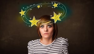 Young girl with yellow stars circleing around her head illustration