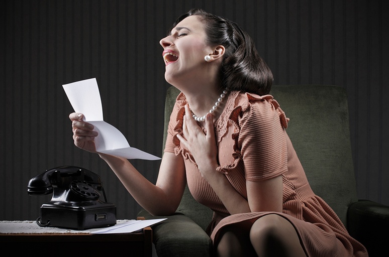 woman laughing at letter