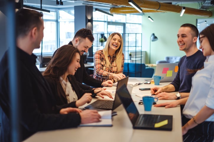 happy coworkers in an office meeting