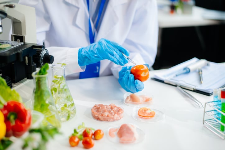 Food scientists in lab coats, testing samples, and analyzing food safety and quality